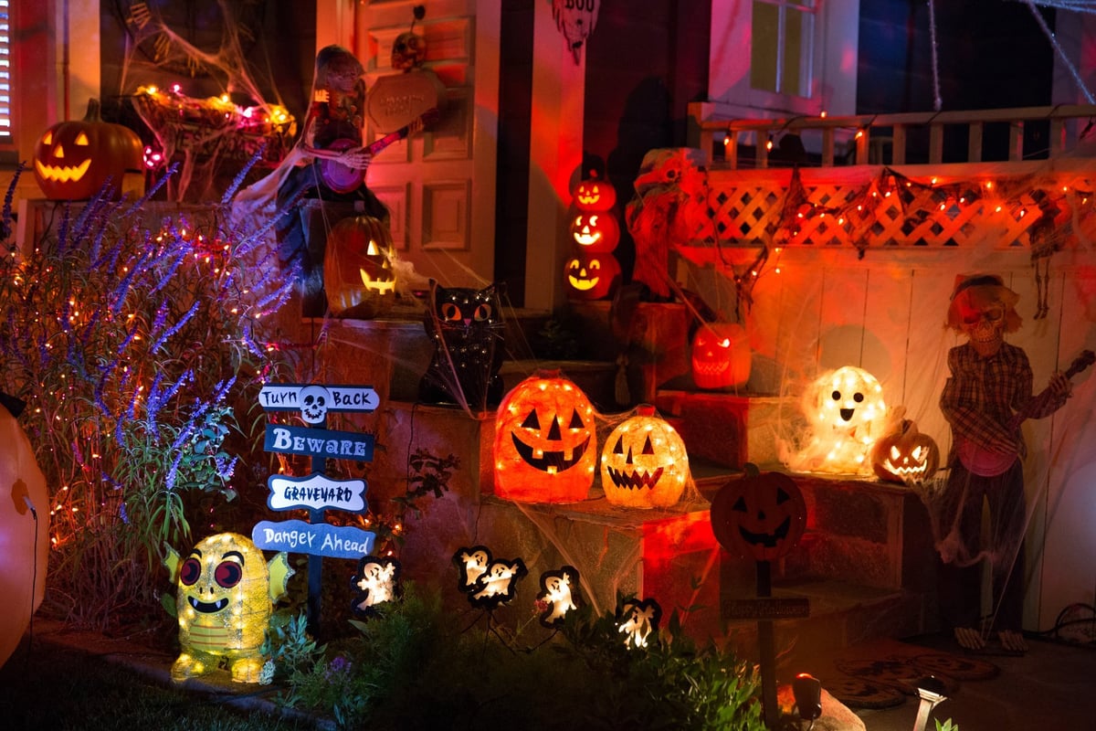 A house with Halloween pumpkins and decorations at Halloween night on a city street